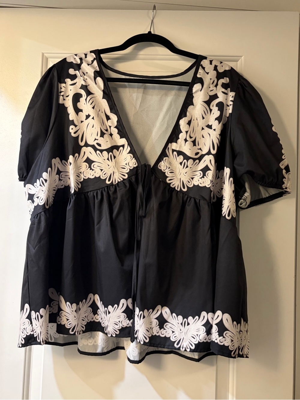 Black V-Neck Peasant Top with White design and toe front